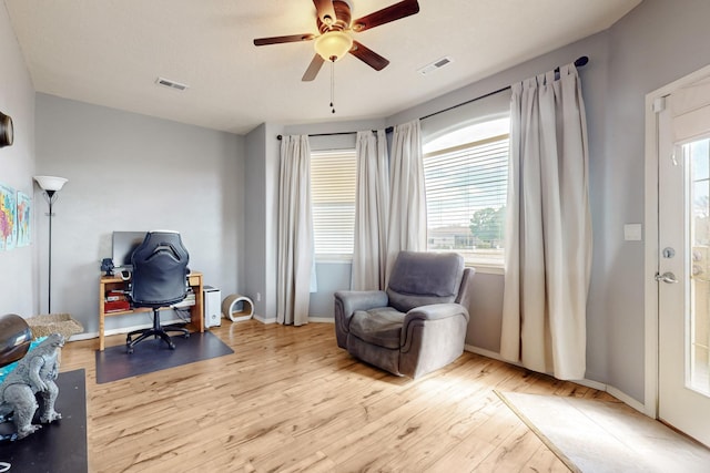 3404 Lockerbie Dr SE, Rio Rancho, NM 87124 - living area featuring a wealth of natural light, wood finished floors, and visible vents