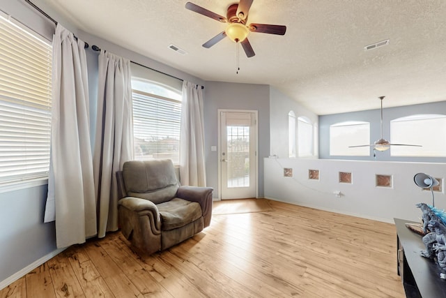 3404 Lockerbie Dr SE, Rio Rancho, NM 87124 - living area with visible vents, light wood finished floors, baseboards, and ceiling fan
