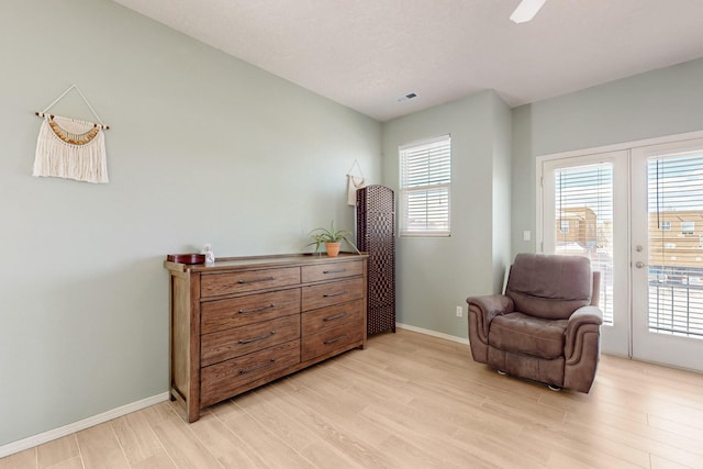 3404 Lockerbie Dr SE, Rio Rancho, NM 87124 - living area featuring a wealth of natural light, light wood-style floors, and baseboards