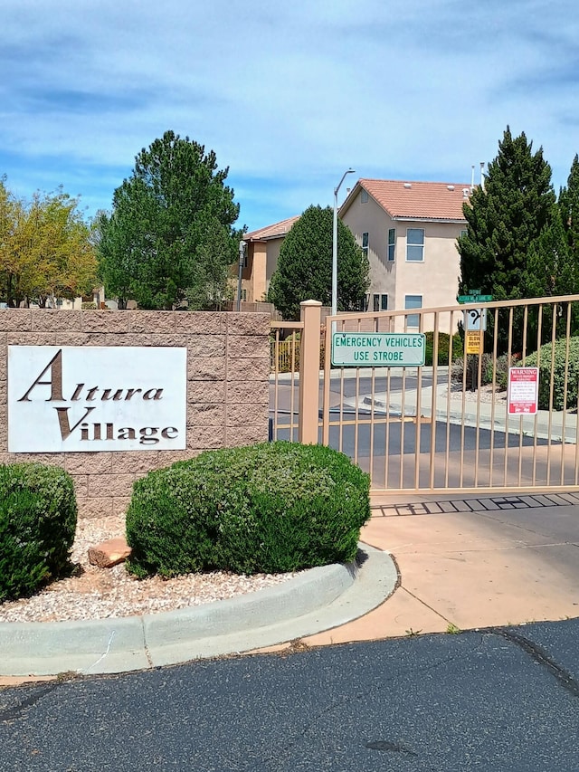 community / neighborhood sign featuring a gate