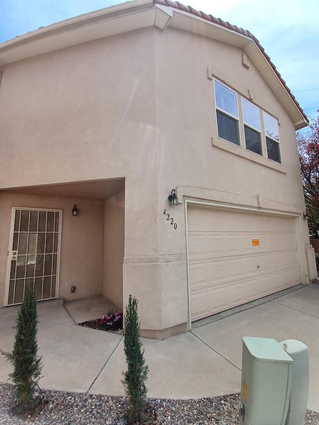 view of front of house with an attached garage and stucco siding