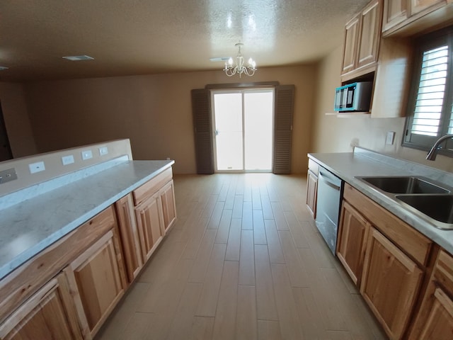 kitchen with light wood finished floors, stainless steel dishwasher, a textured ceiling, a sink, and a chandelier