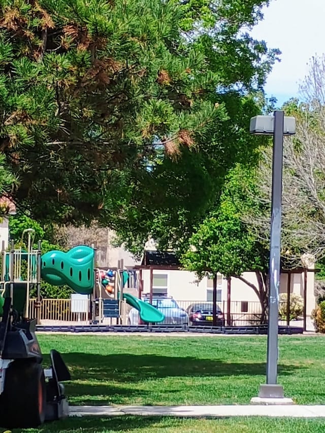 surrounding community featuring a lawn and playground community