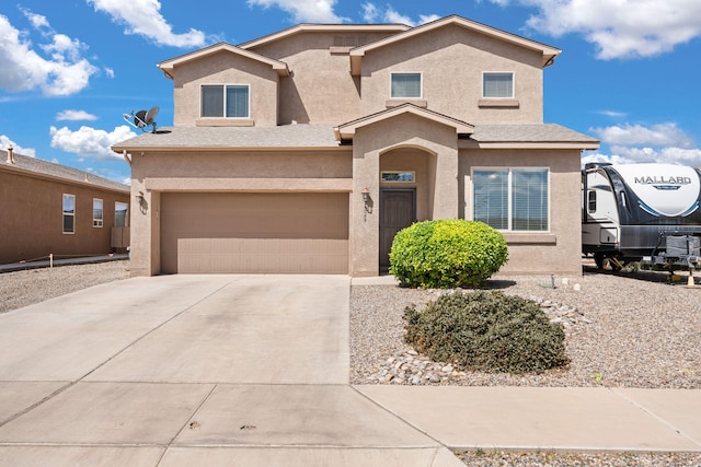 traditional-style house with stucco siding, driveway, and a garage