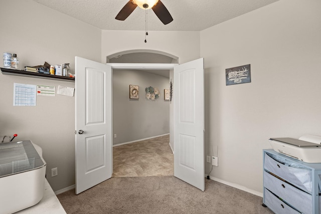carpeted bedroom with a ceiling fan and baseboards