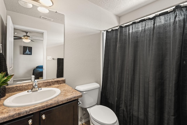 full bathroom with a textured ceiling, visible vents, toilet, vanity, and a ceiling fan