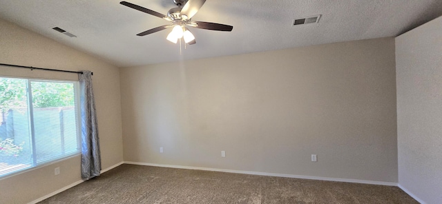 carpeted spare room with baseboards, visible vents, a ceiling fan, and vaulted ceiling