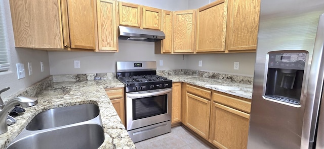 kitchen featuring a sink, stainless steel appliances, under cabinet range hood, light tile patterned flooring, and light stone counters