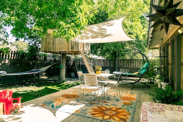 view of patio / terrace with a fenced backyard, a wooden deck, and outdoor dining area