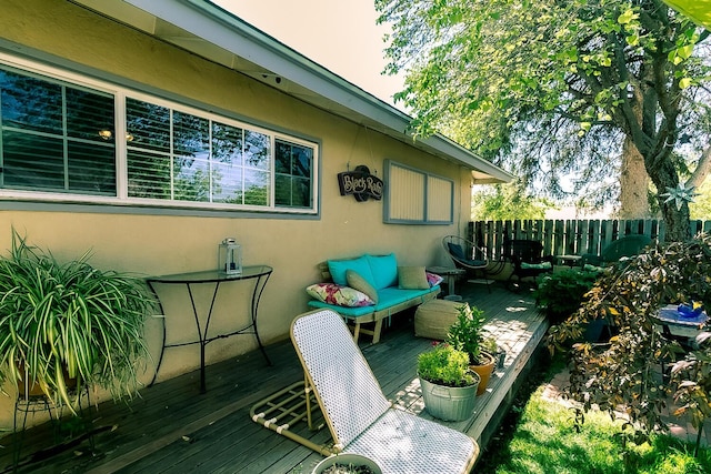 exterior space featuring fence and a deck
