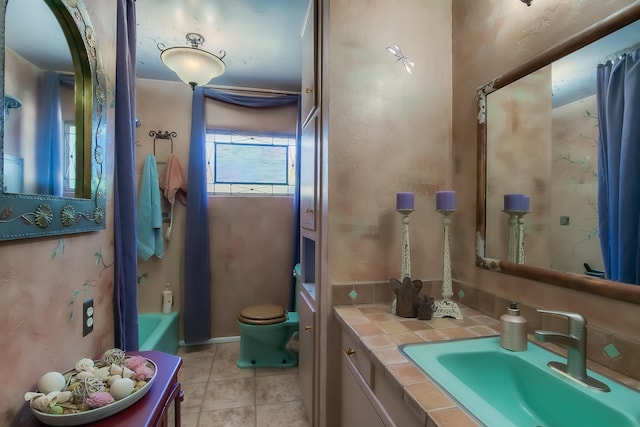 bathroom featuring shower / tub combo, toilet, vanity, and tile patterned floors