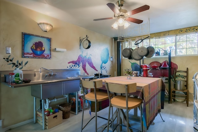 dining area with a ceiling fan and wood finished floors