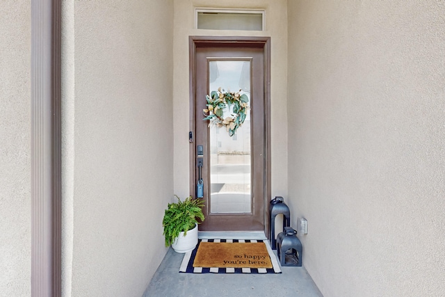 view of exterior entry with stucco siding