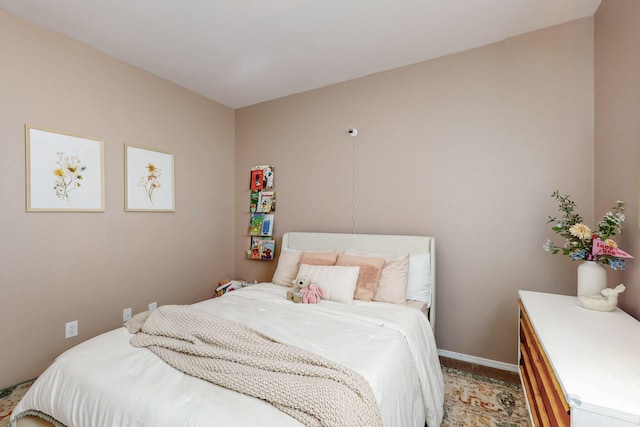carpeted bedroom featuring baseboards