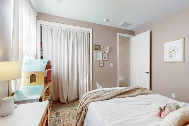 bedroom featuring carpet floors and visible vents