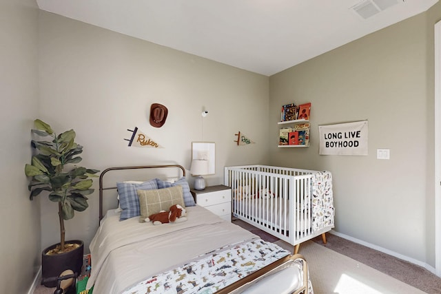 carpeted bedroom with visible vents and baseboards