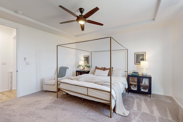 carpeted bedroom with a ceiling fan and baseboards