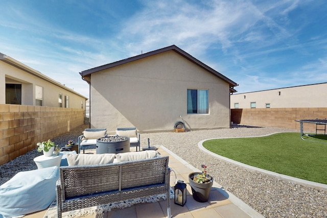 back of house featuring an outdoor hangout area, a patio area, a fenced backyard, and stucco siding