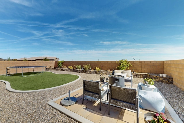 view of patio / terrace featuring a fenced backyard, a trampoline, and an outdoor hangout area