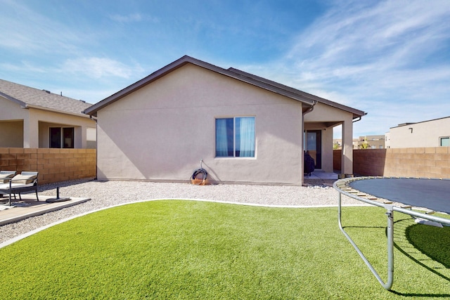 rear view of property with a lawn, a patio, a fenced backyard, and stucco siding
