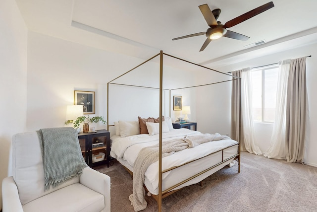 carpeted bedroom featuring visible vents and ceiling fan