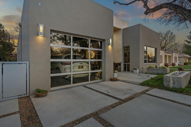 back of house with stucco siding and a patio area