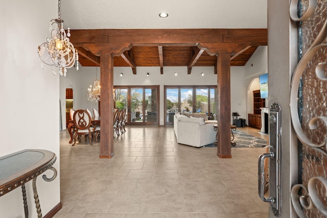 living room featuring arched walkways, a chandelier, beamed ceiling, wood ceiling, and light tile patterned floors