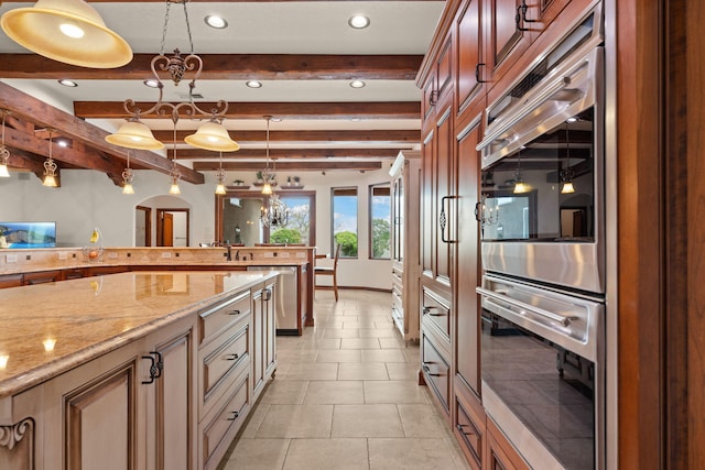 kitchen with stainless steel appliances, arched walkways, recessed lighting, light stone counters, and decorative light fixtures