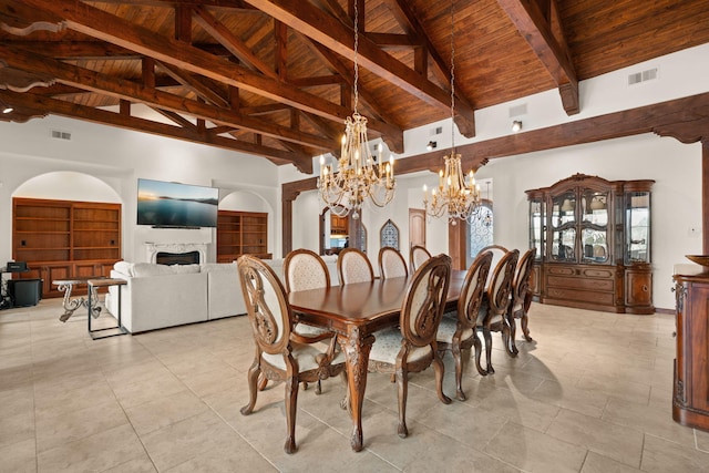 dining room featuring wooden ceiling, a notable chandelier, visible vents, and a fireplace