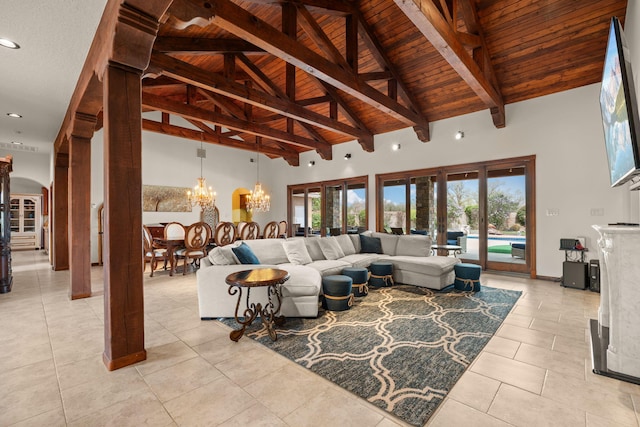 living room featuring a high ceiling, light tile patterned floors, arched walkways, wood ceiling, and a chandelier