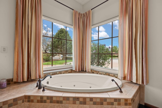 bathroom featuring a tub with jets
