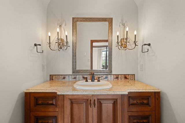 bathroom featuring a chandelier and vanity