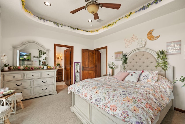 bedroom with light carpet, ensuite bathroom, visible vents, and recessed lighting