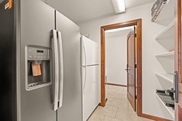 kitchen with light tile patterned floors and stainless steel fridge with ice dispenser