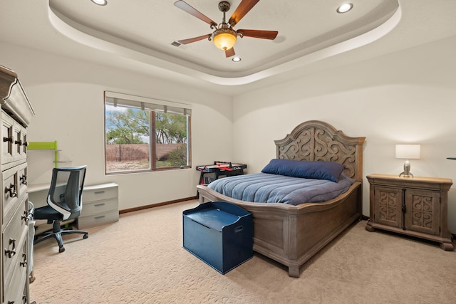 bedroom with visible vents, light carpet, a tray ceiling, and recessed lighting