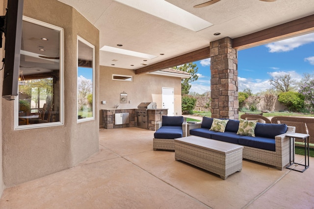 view of patio / terrace with grilling area, an outdoor living space, an outdoor kitchen, and a sink