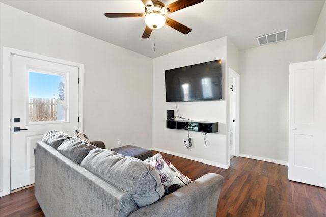 living area featuring baseboards, a ceiling fan, wood finished floors, and visible vents