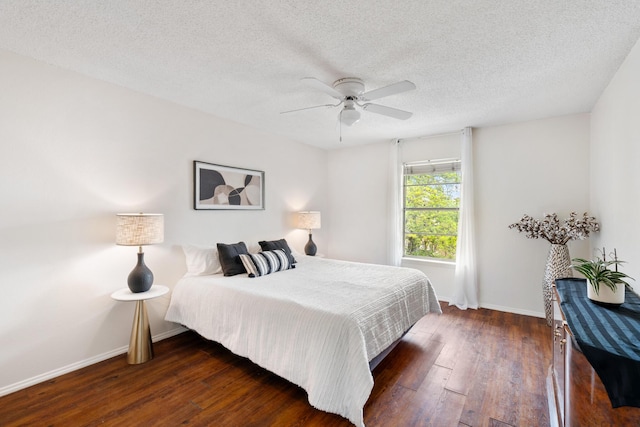 bedroom featuring hardwood / wood-style floors, a ceiling fan, baseboards, and a textured ceiling