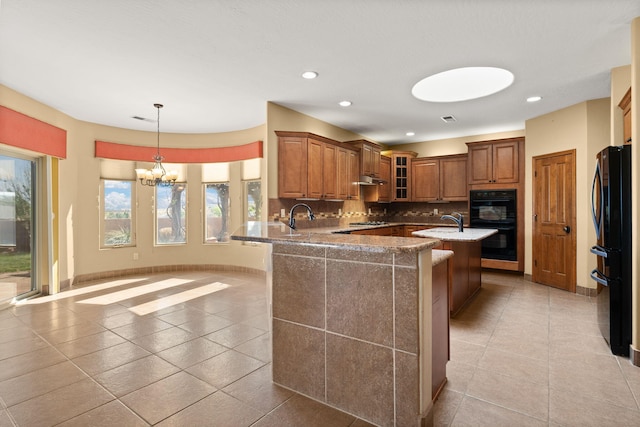 5720 Rio Lama Rd NE, Rio Rancho, NM 87144 - kitchen with light tile patterned flooring, brown cabinets, tasteful backsplash, and plenty of natural light