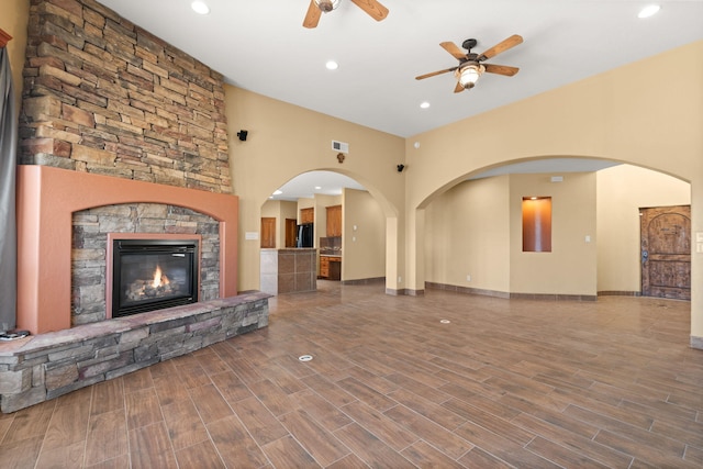 5720 Rio Lama Rd NE, Rio Rancho, NM 87144 - unfurnished living room featuring a towering ceiling, ceiling fan, recessed lighting, and a stone fireplace