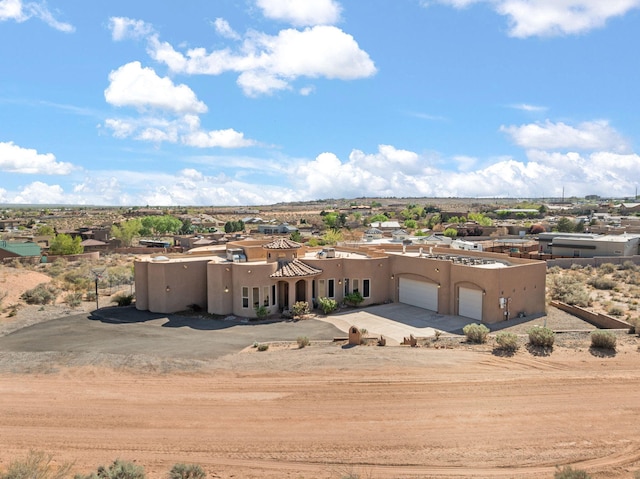 5720 Rio Lama Rd NE, Rio Rancho, NM 87144 - southwest-style home featuring stucco siding, concrete driveway, and an attached garage