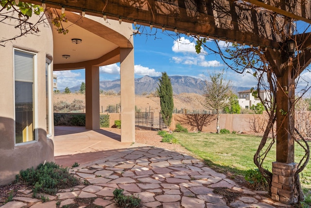 5720 Rio Lama Rd NE, Rio Rancho, NM 87144 - view of patio featuring fence and a mountain view