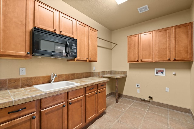 5720 Rio Lama Rd NE, Rio Rancho, NM 87144 - clothes washing area with hookup for an electric dryer, hookup for a gas dryer, a sink, visible vents, and hookup for a washing machine