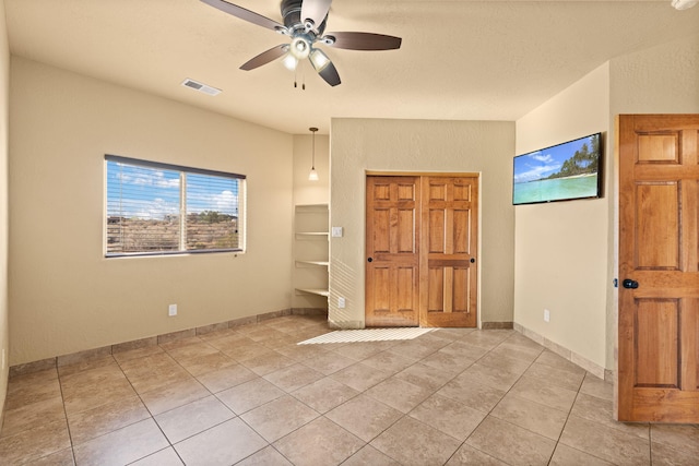 5720 Rio Lama Rd NE, Rio Rancho, NM 87144 - spare room featuring light tile patterned floors, ceiling fan, baseboards, and visible vents