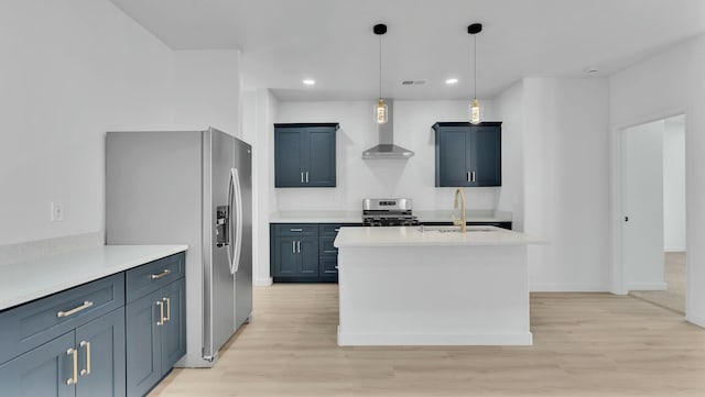 kitchen featuring wall chimney exhaust hood, a sink, light wood-type flooring, and appliances with stainless steel finishes