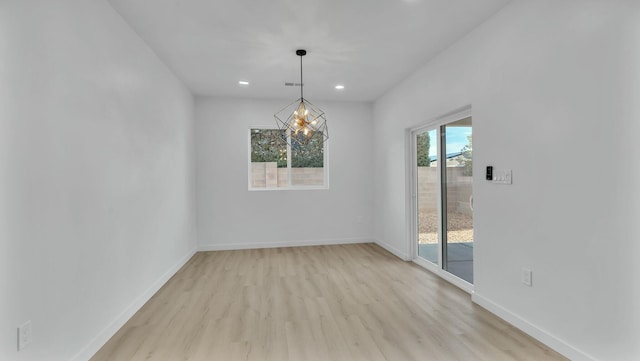 unfurnished room with light wood-style floors, baseboards, a notable chandelier, visible vents, and recessed lighting