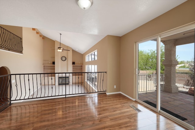 10516 Calle Sombra NW, Albuquerque, NM 87114 - spare room with vaulted ceiling, baseboards, visible vents, a ceiling fan, and wood finished floors