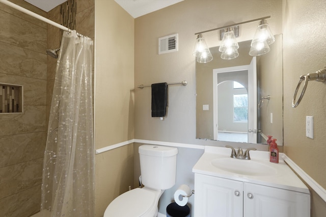 10516 Calle Sombra NW, Albuquerque, NM 87114 - full bathroom featuring a tile shower, visible vents, toilet, and vanity