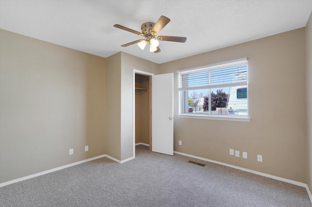 10516 Calle Sombra NW, Albuquerque, NM 87114 - unfurnished bedroom featuring carpet, visible vents, a closet, baseboards, and ceiling fan