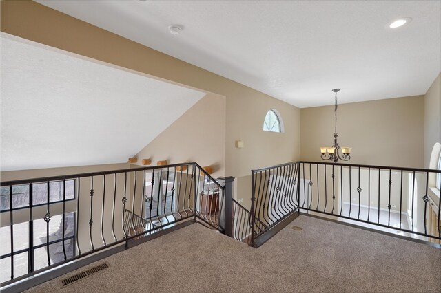 10516 Calle Sombra NW, Albuquerque, NM 87114 - corridor with an upstairs landing, a chandelier, visible vents, and carpet